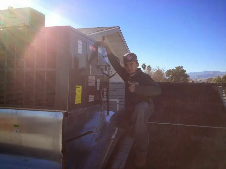 HVAC technician performing HVAC Inspection on a rooftop unit in Fruitville